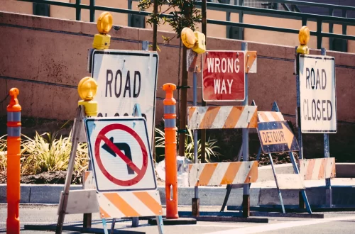 road signs warning of a road closure ahead